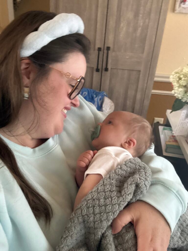 Megan holding her baby during a quiet moment at home.